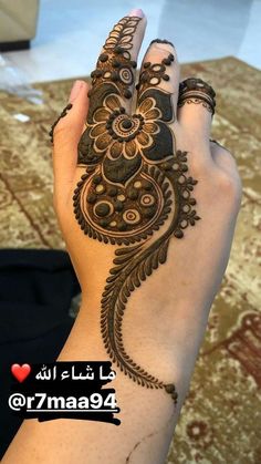 a woman's hand is decorated with hennap and intricate designs on it