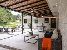 an outdoor living area with couches, tables and chairs