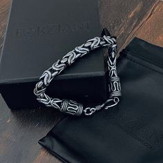 Our Roman Bracelet bracelet boasts an intricate Byzantine weave technique, a testament to Roman chain-weaving artistry since the 19th century. Each link is skillfully handcrafted for a smooth, comfortable feel. Constructed from stainless steel and polished to a luxe oxidized finish, it's designed to stand the test of time, making this the ideal accessory for any occasion. Roman Weave Link Bracelet Bracelet Width: 10mm Wide Core Material: Stainless Steel Finish: Oxidized Finish Clasp: Toggle Clos Roman Bracelet, Link Chain Bracelet, Meaningful Jewelry, Bracelet For Men, Link Chain, Link Bracelets, Chain Bracelet, Bracelets For Men, Jewelry Pieces