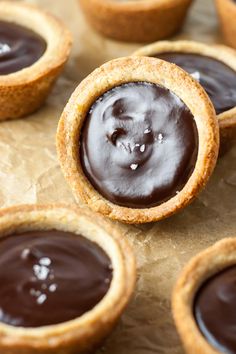 chocolate covered cookies sitting on top of a piece of parchment paper next to each other