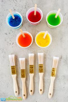 six paint brushes with different colors in them