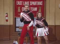 two people dressed in cheerleader outfits standing on stage