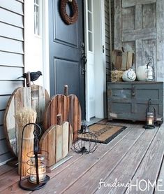 the front porch is decorated for halloween with pumpkins and other decorations