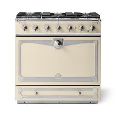 a cream colored stove with four burners and two oven doors on each side, in front of a white background