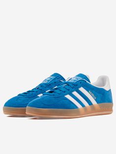 A remake of the 1979 Gazelle Indoor, the sneakers most favored by soccer fans and sneakerheads alike. A blue suede upper and durable leather lining combine with a translucent rubber outsole. The 3 stripes and gold metallic lettering complete the iconic look.
  Suede upper
 Lace-up closure
 Leather lining
 Rubber sole
 Blue



Size & Fit:
Fit regular