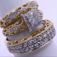 two gold rings with white diamonds on them