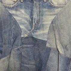 two pairs of blue jeans sitting on top of each other