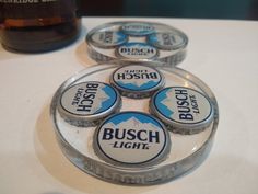 four beer bottle caps sitting on top of a table