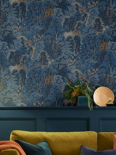 a living room with blue and gold wallpaper