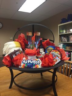 a table topped with lots of candy and candies on top of a wooden table