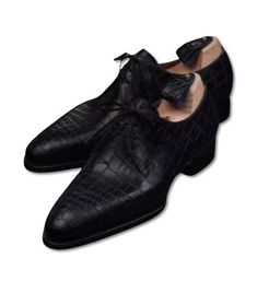 Pure Handmade Black Color Crocodile Leather Lace-Up Dress Shoes For Men Description: These Pure Handmade Black Crocodile Leather Lace-Up Dress Shoes for Men are a masterpiece of luxury and craftsmanship. Made from genuine crocodile leather, these shoes exude elegance and sophistication. The rich black color enhances their sleek, timeless design, making them the perfect choice for formal occasions or upscale events. The lace-up closure offers a classic touch, ensuring a secure and comfortable fit Black Crocodile Pattern Oxfords For Business, Fitted Black Dress Shoes With Crocodile Pattern, Semi-formal Black Leather Shoes With Crocodile Pattern, Semi-formal Black Crocodile Pattern Leather Shoes, Black Crocodile Pattern Wingtip Oxfords, Black Crocodile Pattern Leather Shoes For Business, Black Crocodile Pattern Leather Shoes For Office, Black Leather Shoes With Crocodile Pattern For Business, Black Crocodile Pattern Leather Office Shoes