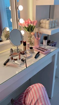 a vanity with makeup and flowers on it