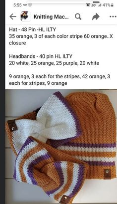 an orange and white knitted beanie with a bow on the top, sitting next to another hat