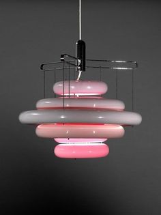 a multi colored light fixture hanging from a ceiling