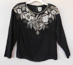 "Gorgeous looking pullover top/blouse Black silk with gorgeous floral design with pearls Neckline ,cuffs and waistline embellished with pearls and beads - refer to photos Beads sequin front & back Back hook closure Shell - 100% silk, lining - 100% rayon Great condition Dimension shoulder 40\" bust 42\" sleeve 19\" length 24\"" Elegant Embellished Holiday Blouse, Elegant Embellished Tops For Festive Season, Spring Embellished Silk Tops, Embellished Formal Top For Fall, Elegant Embellished Tops For Spring, Formal Embellished Tops For Fall, Elegant Beaded Tops For Night Out, Elegant Silk Blouse With Sequins, Holiday Embellished Top For Evening