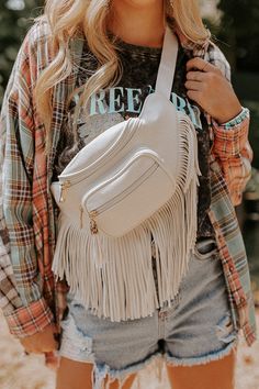 - This casual bag has boho flair! - Sleek lightweight material with long fringe detailing - Two zip closure front pockets - An adjustable shoulder strap - A spacious fully lined interior with a zip closure and additional inside zip closure pocket Beige Fringe Shoulder Bag For Travel, Cream Hobo Bag For Travel With Zipper Closure, Cream Hobo Bag With Zipper For Travel, White Tassel Shoulder Bag For Travel, White Fringe Travel Bag, Cream Bags With Tassels, White Fringe Shoulder Bag For Everyday Use, Daily White Shoulder Bag With Fringe, Long Fringe