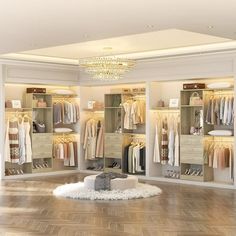 a large walk in closet with lots of clothes on shelves and chandelier hanging from the ceiling