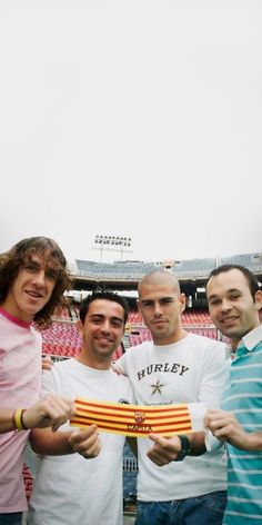 three men are posing for the camera while holding a striped object in front of them