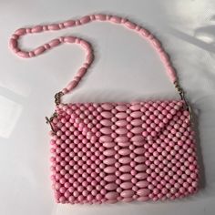 1960s 1970s pink bead purse. Beads are plastic. Small size 9 1/2" wide x 6" tall x 1" Chain / handle. Total amount is 30" with 10" drop. The lining is spotted all over Otherwise bag is in good condition. You could make a new lining and stitch to old lining pretty easy. tag says Hong Kong weighs 1 lb 2 ozs Bead Purse, Beaded Handbag, Beaded Purses, Pink Beads, Purses And Handbags, Hong Kong, Shoulder Bags, 1970s, 1960s