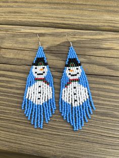 the beaded snowman earrings are made with blue seed beads