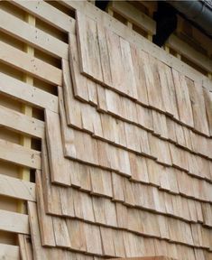 a close up of a wooden building with a white arrow on it's side