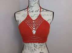 Burnt Orange Crocheted Caged Halter top.  Great for the beach, outdoor festivals and concerts or hanging out with friends.  Straps around neck and waist are adjustable to conform your body.  This top is made with 100% cotton, making it lightweight, comfortable and breathable.  A great addition for your summer wardrobe.   Size:   Orange - Medium.  Fitted for B sized Cup that is unlined and unpadded. Care: Machine wash gentle, Flat Dry and Low Heat Iron Availability: This top is available for imme Orange Halter Top For Summer Beach, Orange Summer Halter Top For Beach, Orange Halter Top For Spring Beach Occasions, Orange Halter Top For Beach In Spring, Fitted Halter Top For Beach Festivals, Festival Beach Fitted Halter Top, Festival Fitted Halter Top For Beach, Festival Halter Top For Beach, Stretch Halter Top For Spring Festival