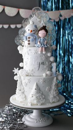 a white cake with frosting and snowmen on top