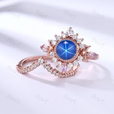 a ring with blue stone surrounded by diamonds