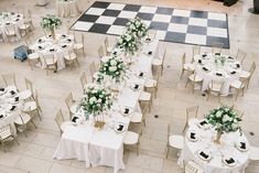 an overhead view of tables and chairs set up for a formal function with flowers on them