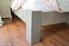 a bed sitting on top of a wooden floor