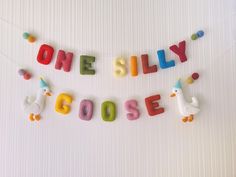 the word silly spelled out in colorful letters on a string with toys hanging from it