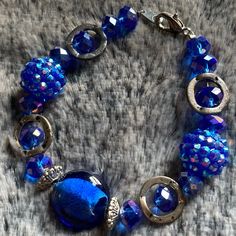 Blue Glass Bracelet W/Rhinestones & Silver Accents Length: 7 1/4” **All Bracelets Can Be Altered** Shorten In Length Possibly Lengthened Change To Magnetic Clasp Let Me Know Of Any Changes When Purchasing. Any Questions? Just Ask. Like An Item But Not The Price? Send An Offer. All Items In My Closet Are Buy 2 Get 1 Free. Handmade Blue Crystal Bracelet For Party, Blue Metal Bracelets With Round Beads, Blue Crystal Bracelet For Party, Elegant Blue Metal Beaded Bracelets, Blue Crystal Beaded Bracelets For Jewelry Making, Elegant Blue Beaded Metal Bracelets, Silver Glass Beaded Bracelets For Parties, Handmade Blue Crystal Beaded Bracelets, Handmade Blue Crystal Party Bracelet