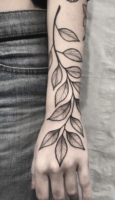 a woman's hand with leaves on it