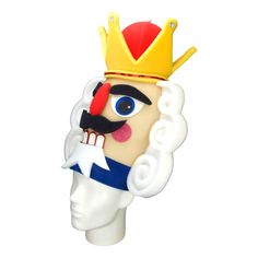 a plastic head wearing a crown and holding a star on it's forehead is shown in front of a white background