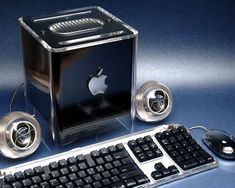 an apple computer sitting on top of a table next to a keyboard and mouse,