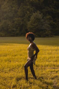 a woman standing in the middle of a field