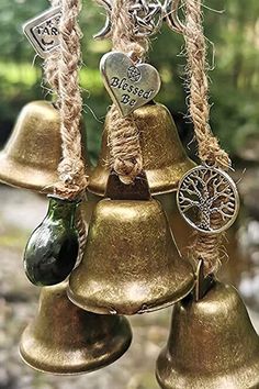 two pictures of bells with charms hanging from them and one has a pentagram on it