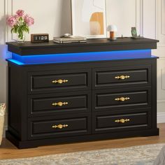 a black dresser with blue lights on top