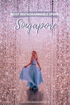 a woman standing in front of a backdrop with the words most instagramable spots singapore