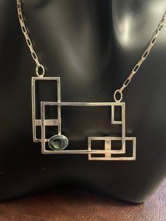 Handcrafted sterling silver necklace using square sterling wire.  Italian sterling elongated box link chain. Rectangular sterling lobster lock. Width of pendant 2 1/16 inches. Height 1 3/4 inches. bezel set opal triplet 3/4 x 1/4 inch. One of a kind creation. Modern Silver Necklace With Rectangular Stone, Rectangular Links Jewelry With Polished Finish For Gift, Silver Rectangular Necklace With Polished Finish, Modern Oblong Jewelry With Polished Finish, Modern Rectangular Jewelry With Polished Finish, Modern Handmade Oblong Jewelry, Modern Necklace With Rectangular Pendant And Box Chain, Polished Rectangular Link Necklace For Gift, Modern Necklace With Rectangular Gemstone