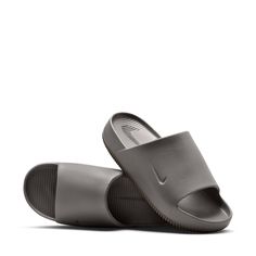 It's all in the name when it comes to these slides by Nike. Slip into a calm state when you wear the Nike Calm minimalist slides with maximum cushioning. The contoured foam is seamlessly created from one piece and cradles your feet to keep them in place. Even better—this slide is quick-drying, making water-related activities even more relaxing. You get all of the style with no extra effort on your end. It's time to slip into your Calm. Allover print. Comfortable slip-on slides. Soft yet responsi Shoes Slides, Nike Open Toe Slides With Textured Footbed, Nike Casual Slides With Textured Footbed, Nike Low-top Slides With Cushioned Footbed, Textured Footbed Slip-on Slides For Streetwear, Nike Non-slip Synthetic Slides, Indoor Slides, Nike Slides, Gym Fits