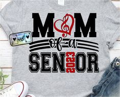 a t - shirt with the words mom of a senior year on it and a cell phone