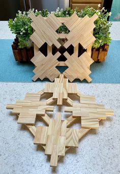 several pieces of wood sitting on top of a table next to potted planters