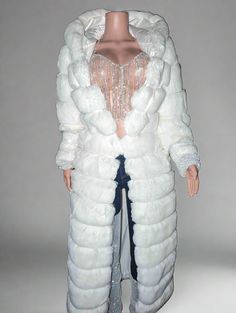 a mannequin wearing a white fur coat