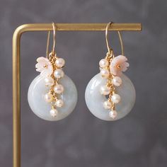 >> Like my design? Follow me on Instagram to stay updated on new arrivals and special discounts http://instagram.com/faithanddeedsjewelry Tasteful and sweet. These beautiful earrings are made with Type A Burmese jade donuts in light green colour, dressed with dainty pink flower cabochon made with mother of pearl and cluster of fresh water pearls that flow gracefully from top of the jade to create a very elegant cascade. A simple yet elegant design for the romantic at heart. Jade donuts mea Jade Round Earrings For Wedding, Round Jade Earrings For Wedding, Elegant Round Jade Earrings For Weddings, Wedding Day Earrings, Donut Earrings, Pearl Cluster Earrings, Burmese Jade, Handmade Fashion Jewelry, Pearl Cluster