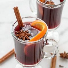 two mugs filled with mulled and cinnamon