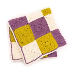 two crocheted dishcloths sitting next to each other on a white surface