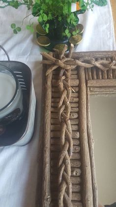 a table with a mirror, potted plant and other items on top of it