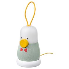 a white and yellow bird with a red bow tie on it's head is sitting in front of a white background