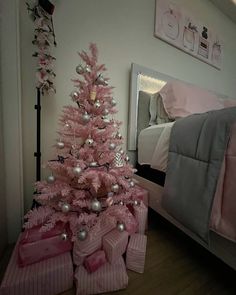 a pink christmas tree with presents under it